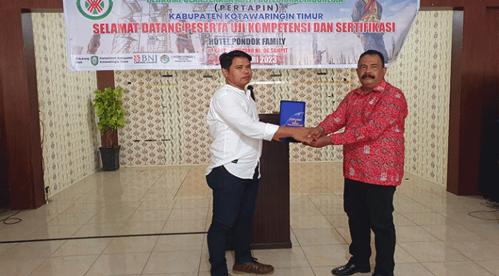 Kepala DPC Pertapin Kotim Rudi Irwandi saat memberikan cindera Mata kepada Kepala Disnakertans Kotim Fuad Sidiq.