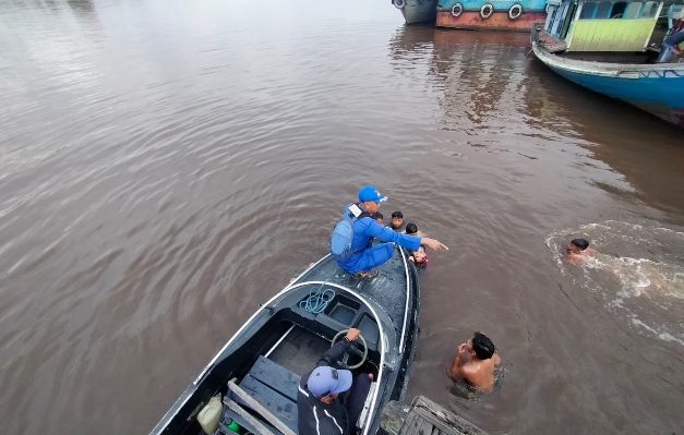 Personel Ditpolairud Polda Kalteng saat mengingatkan warga agar tidak berenang di Sungai Mentaya karena keberadaan buaya yang kerap menyerang manusia.