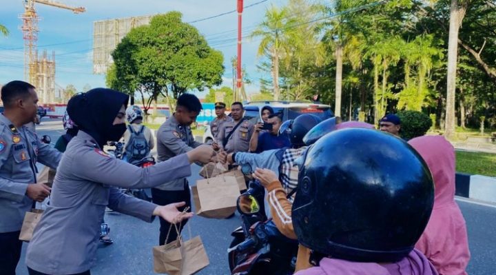 Sejumlah personel Polda Kalteng membagikan paket takjil kepada sekumlah warga yang melintas di Bundaran Besar Palangka Raya Kamis 23 Maret 2023.