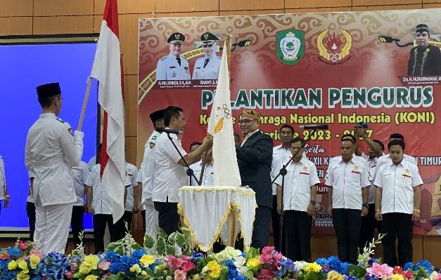 Plt Ketua KONI Kalteng Sancho saat menyerahkan bendera pataka kepada Ketua KONI Kotim Ahyar Umar, saat pelantikan pengurus, Senin, 12 Juni 2023.