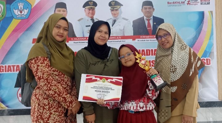 Siswi SD Muhammadiyah Sampit, Naura Nadhifa menerima trofi dan hadiah juara 2 vokal solo FLS2N tingkat Kabupaten Kotim, Selasa, 1 Agustus 2023.