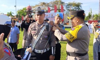 Penyematan pita oleh kapolres Kotim pada petugas lantas dalam Operasi Keselamatan Telabang 2024, Senin, 4 Maret 2024.
