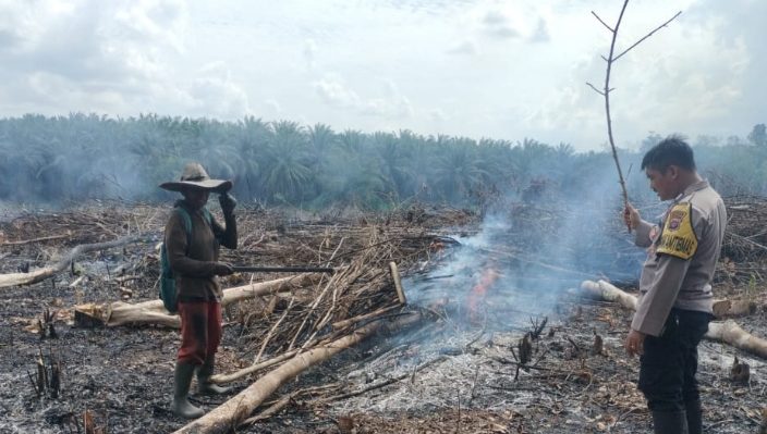 Petugas Polaek Cempaga Hulu saat memadamkan api dibantu warga setempat.